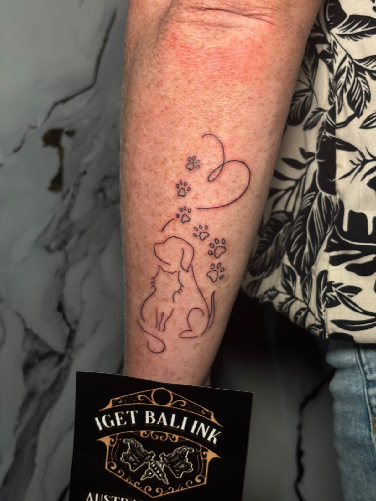 Fine line dog silhouette with paw prints and heart
