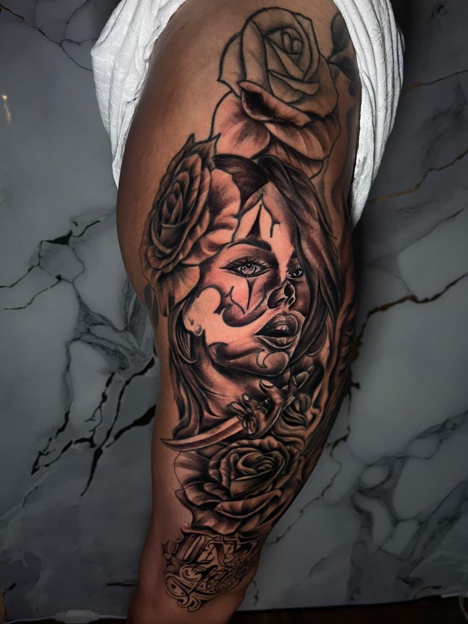 Chicano clown girl with roses thigh tattoo