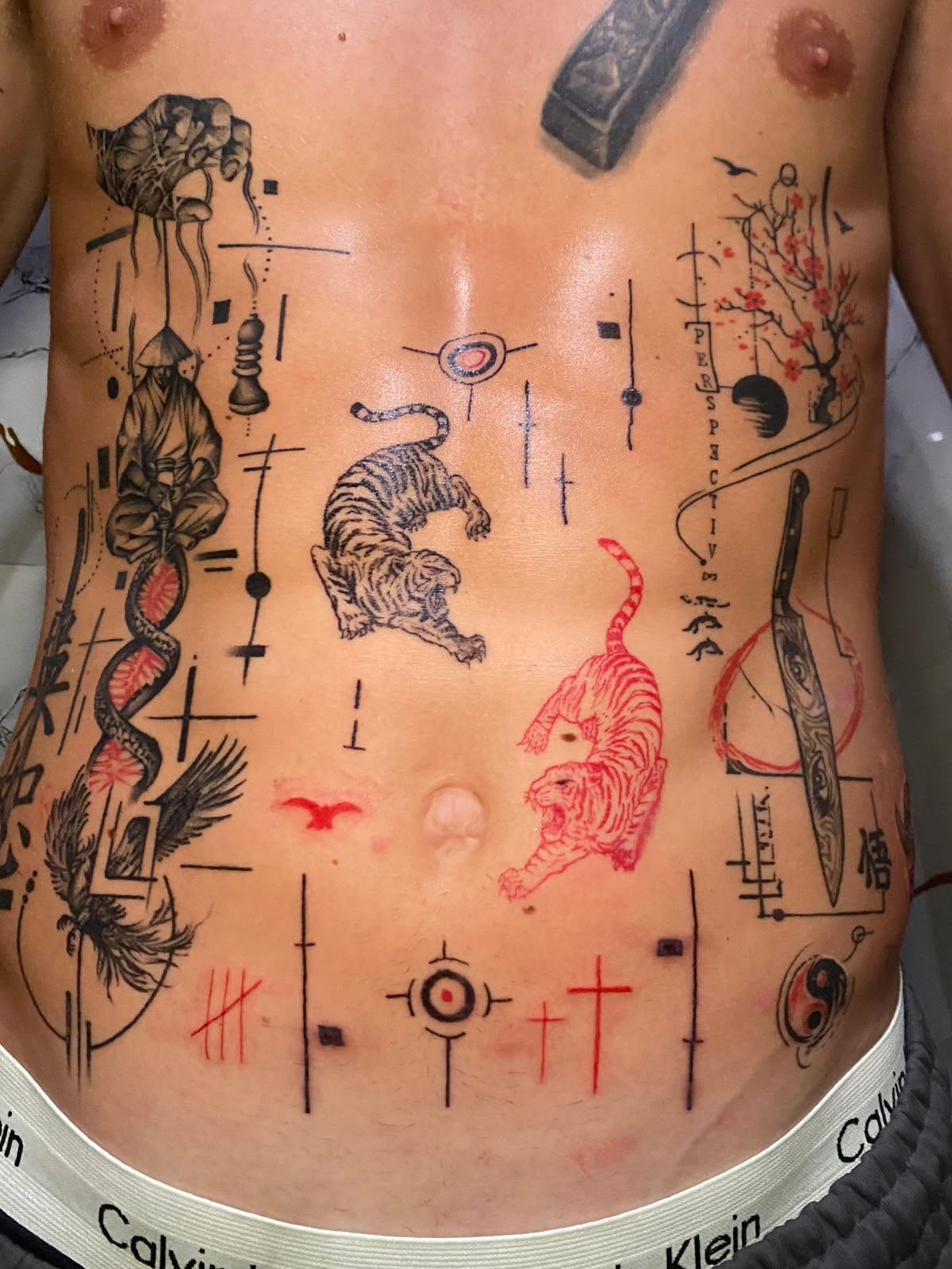 Fine line stomach patchwork with tigers, monk and red linework