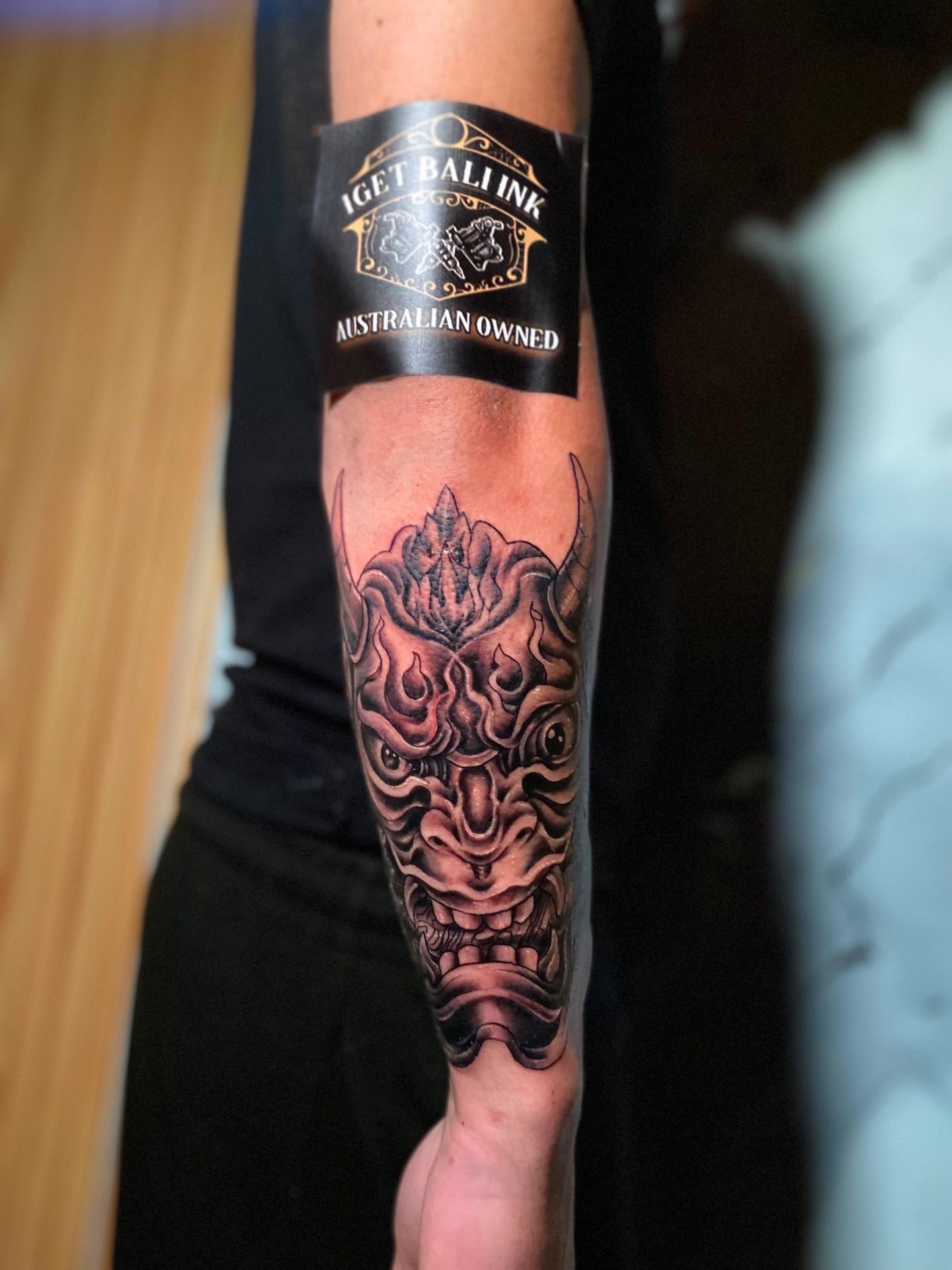 Black and grey hannya mask forearm tattoo