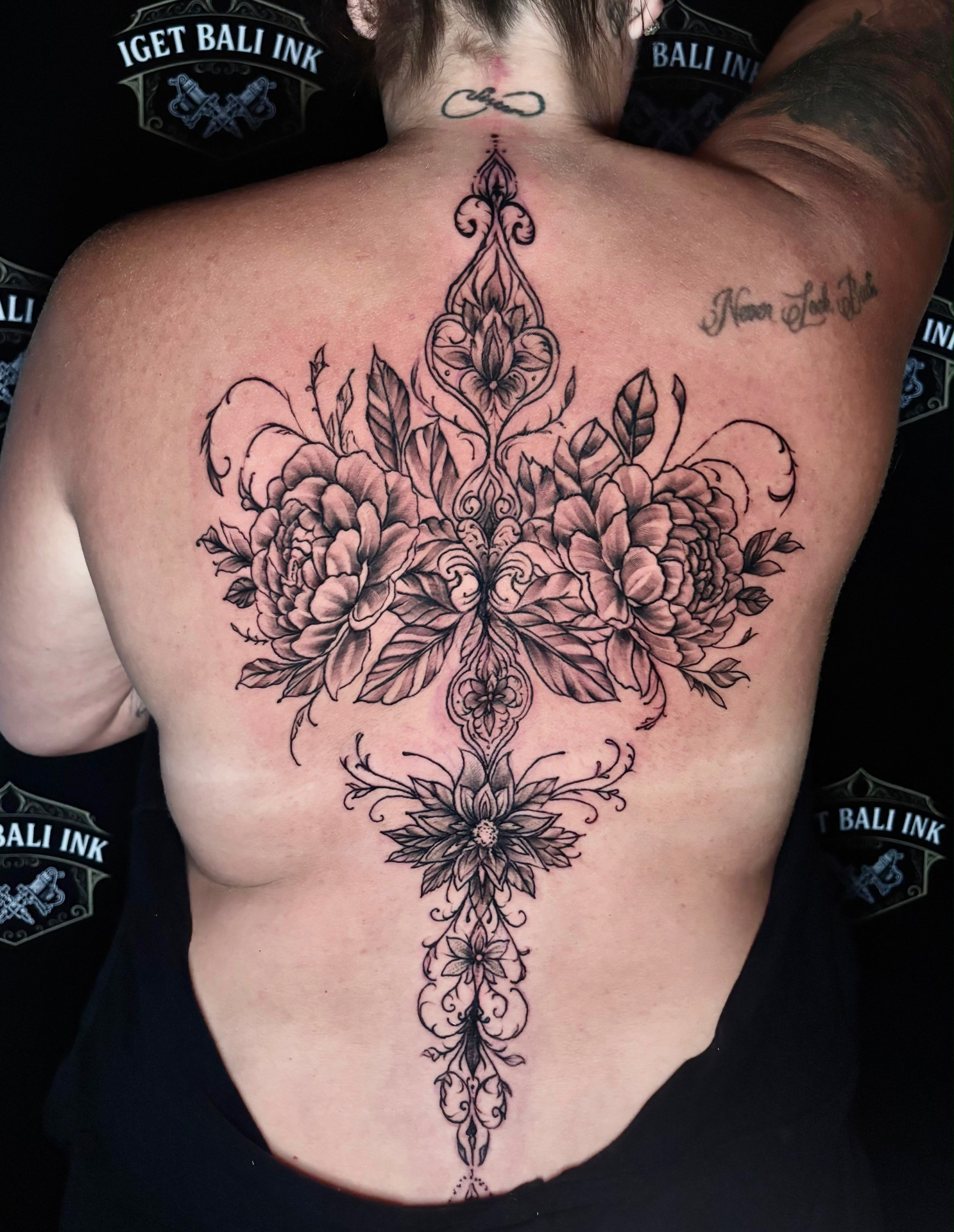 Ornamental floral back piece in fine line black and grey