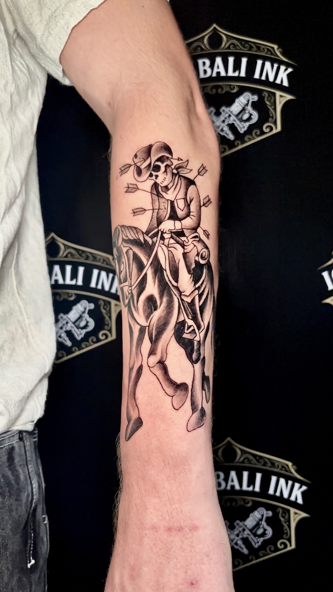 Black and grey skeleton cowboy riding a horse