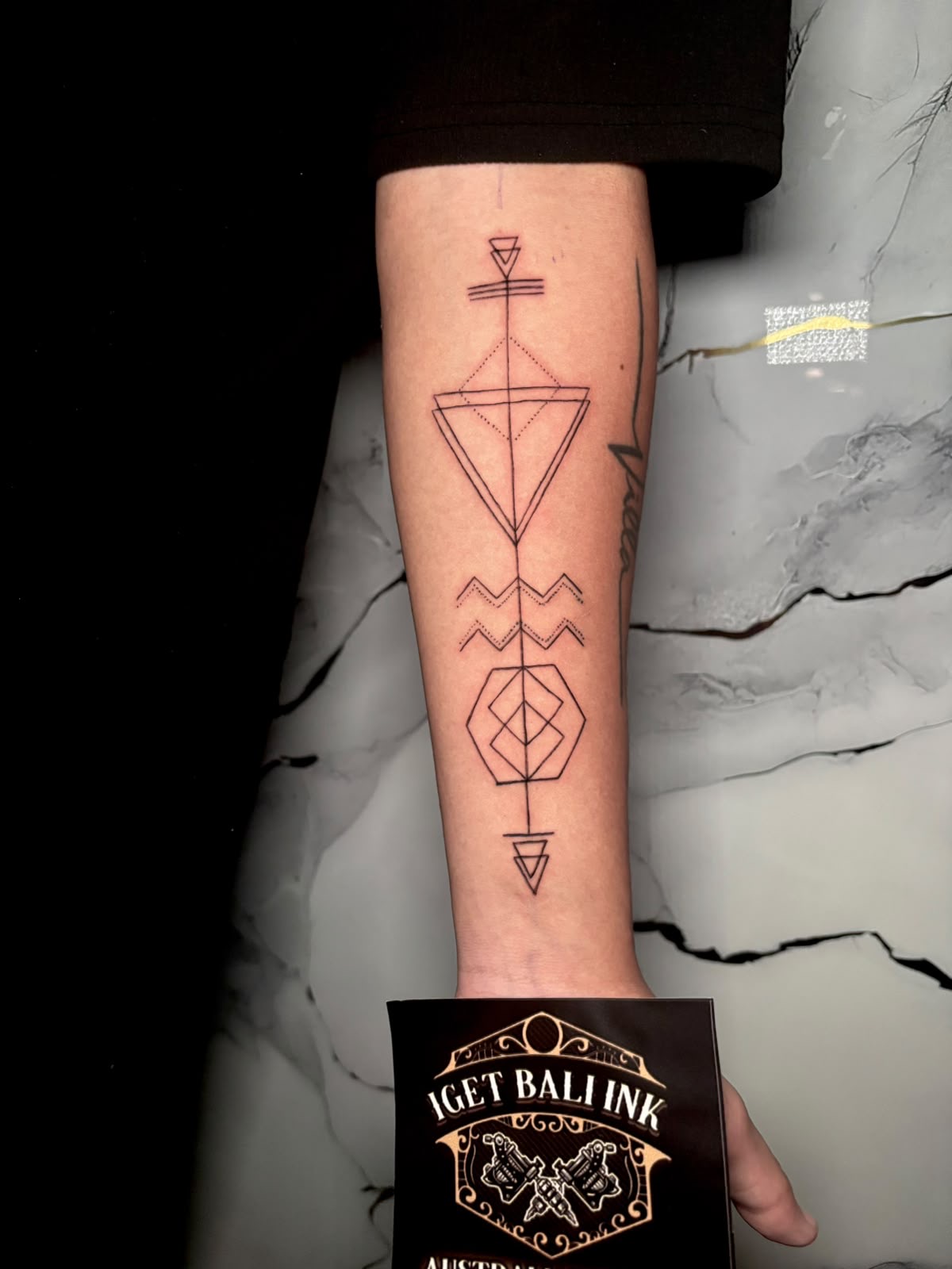 Geometric sacred geometry forearm tattoo in fine line
