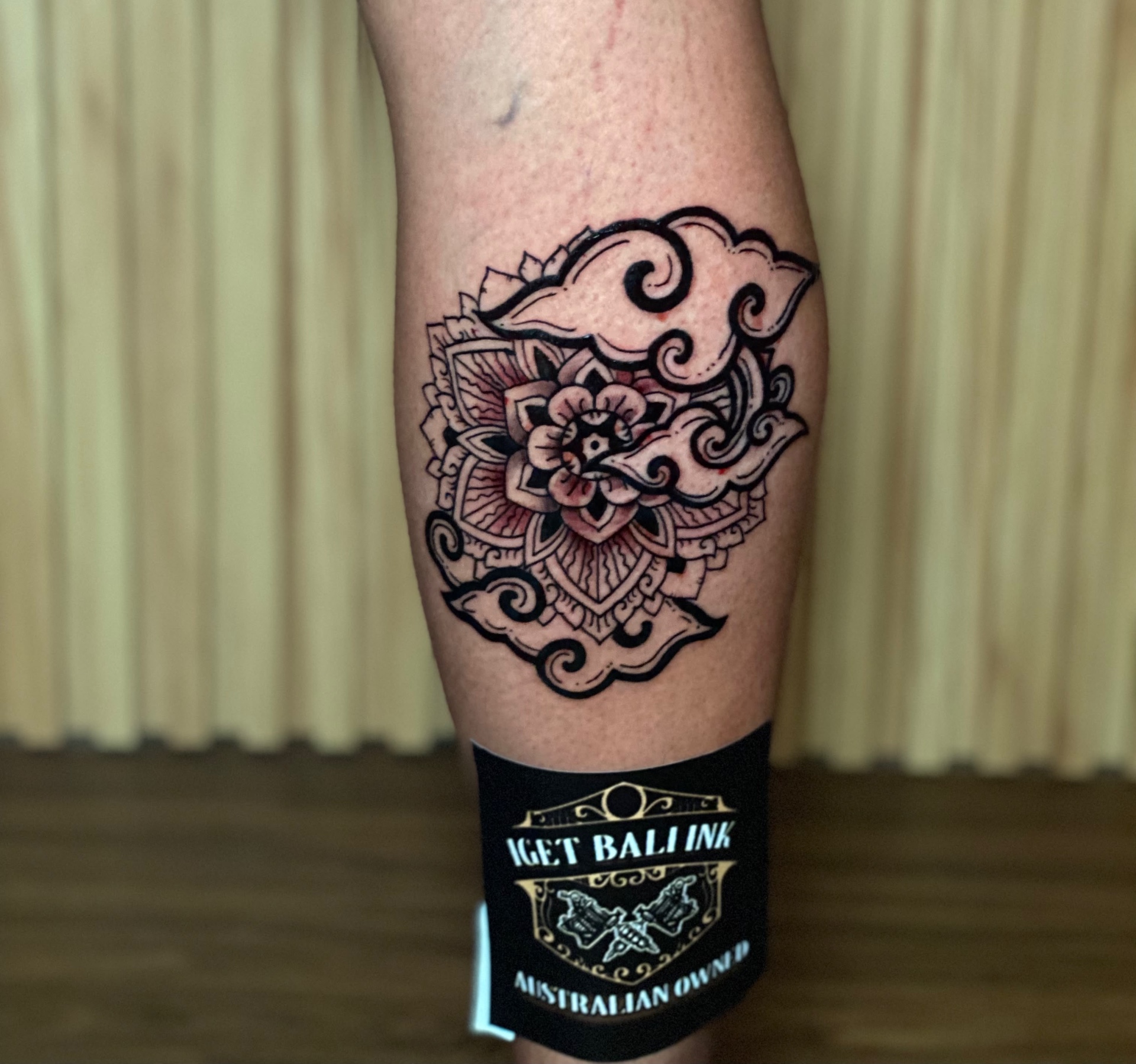 Mandala with clouds calf tattoo in fine line