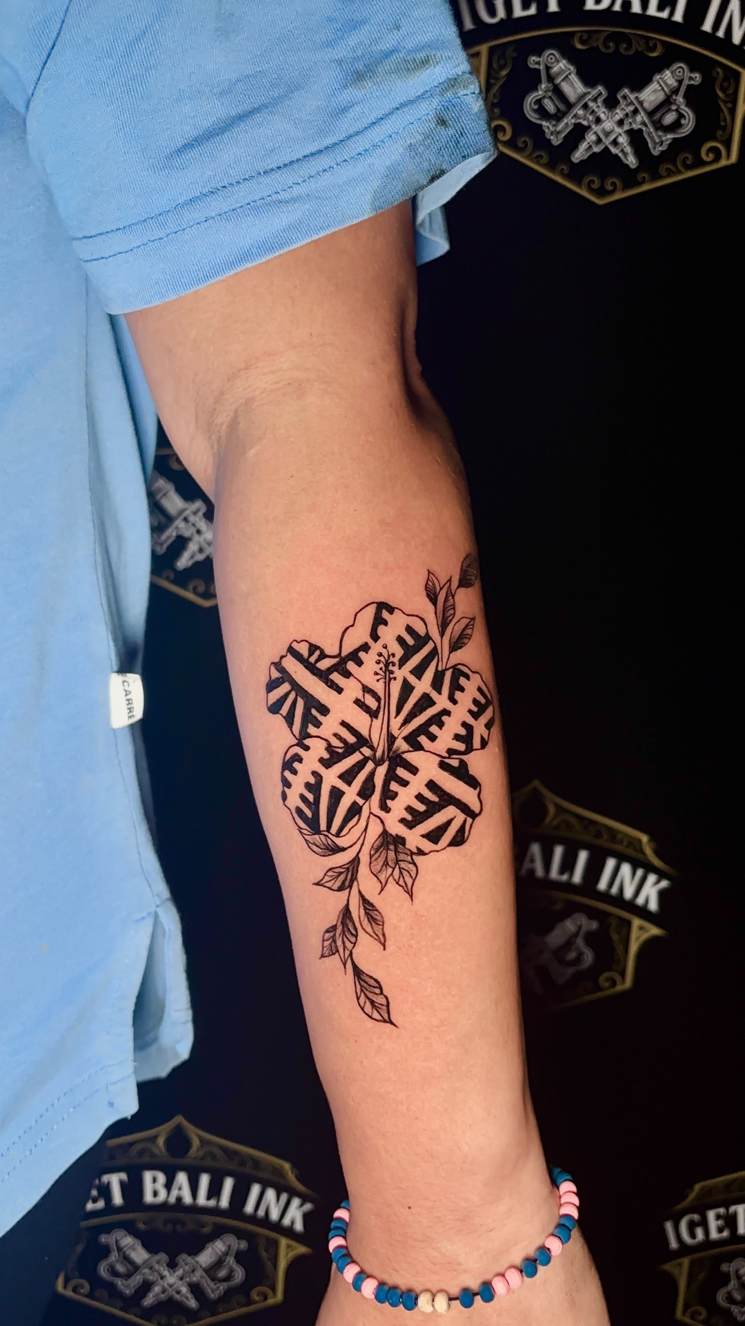 Fine line geometric hibiscus forearm tattoo