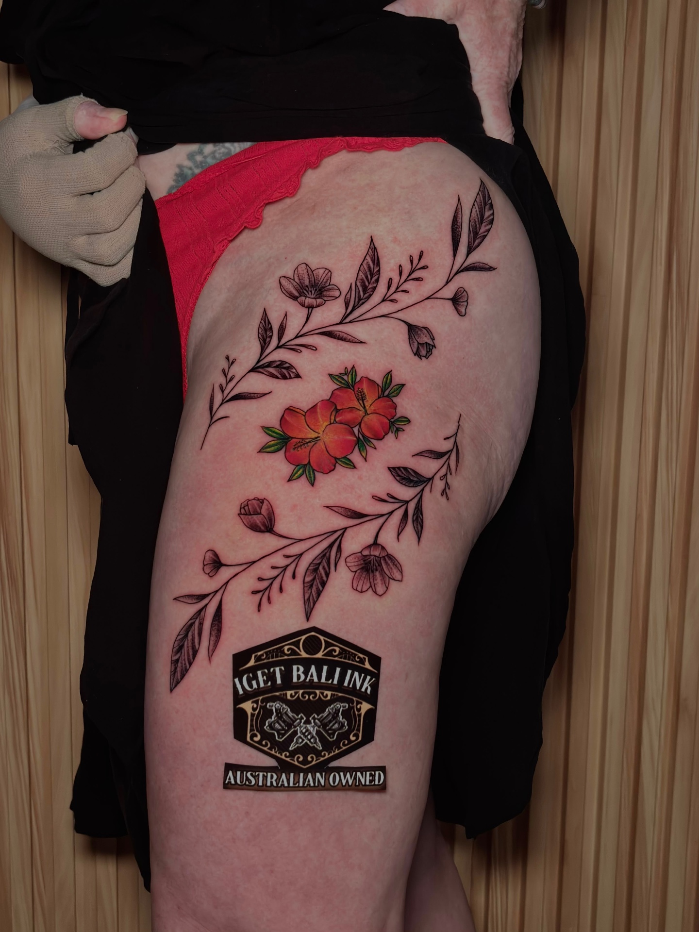 Fine line florals with colour hibiscus on hip