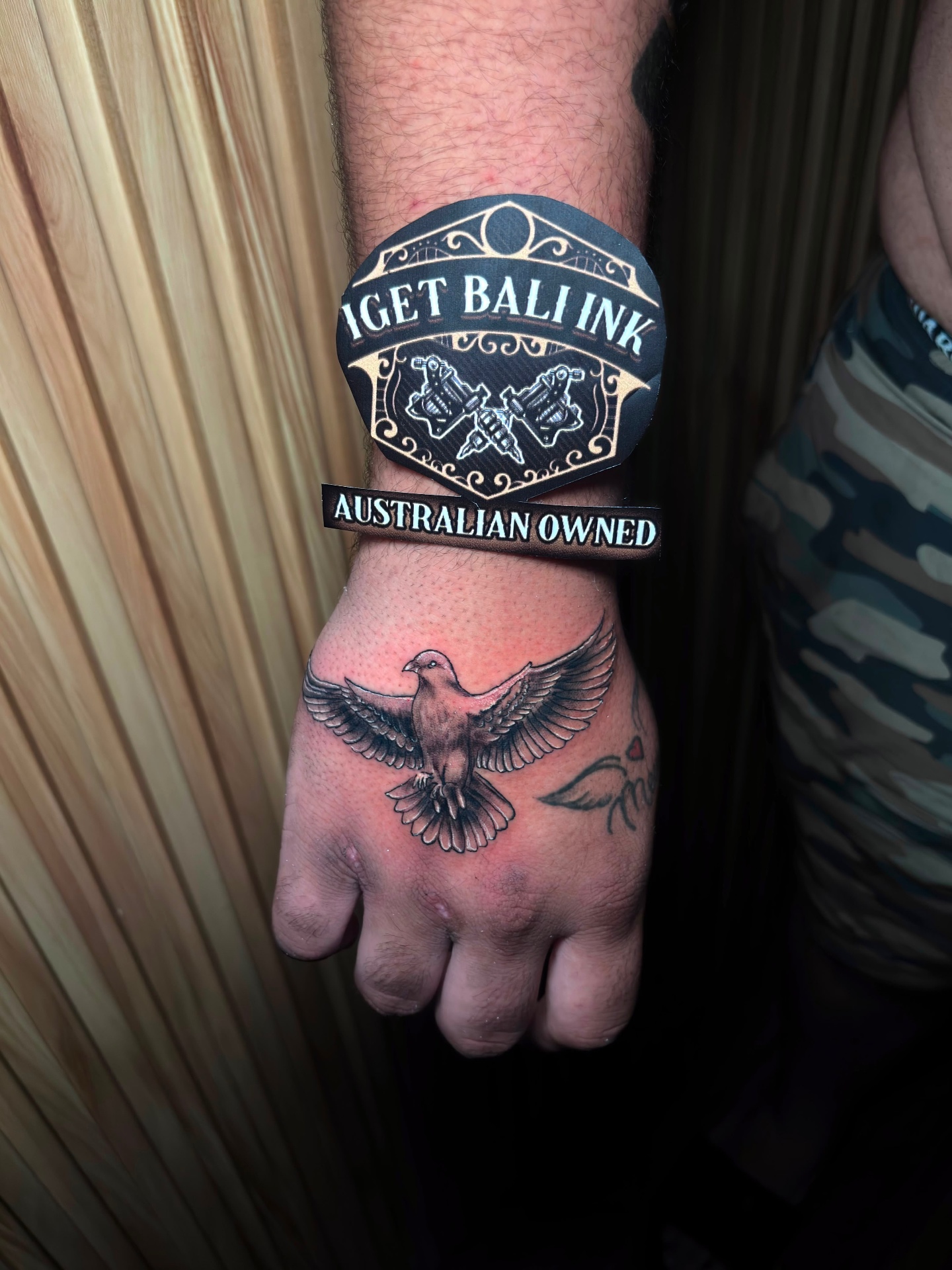 Black and grey dove hand tattoo