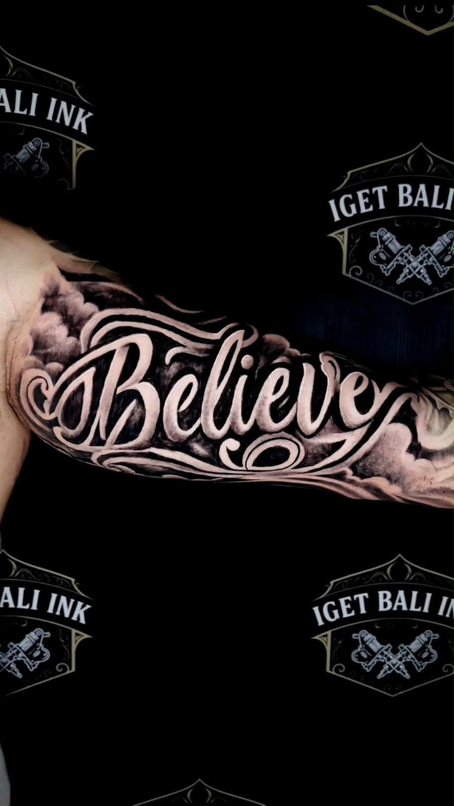 Believe script tattoo with black and grey clouds