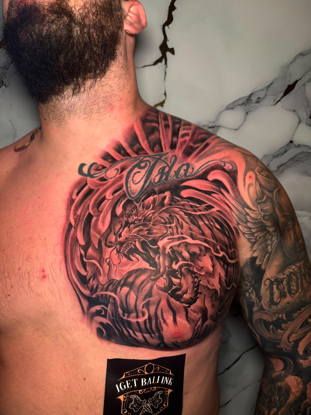 Black and grey Japanese dragon chest piece with Isla script