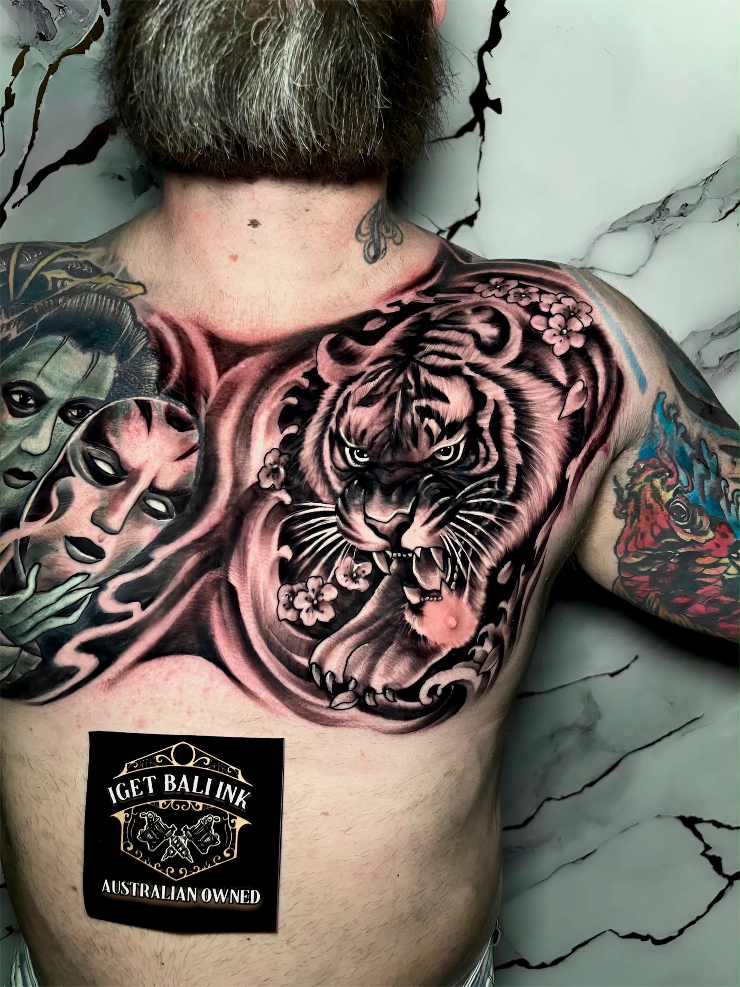 Japanese tiger and cherry blossom chest piece in black and grey