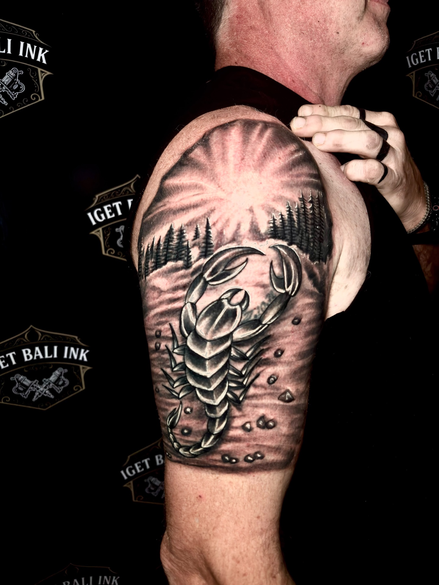 Black and grey scorpion landscape upper arm tattoo
