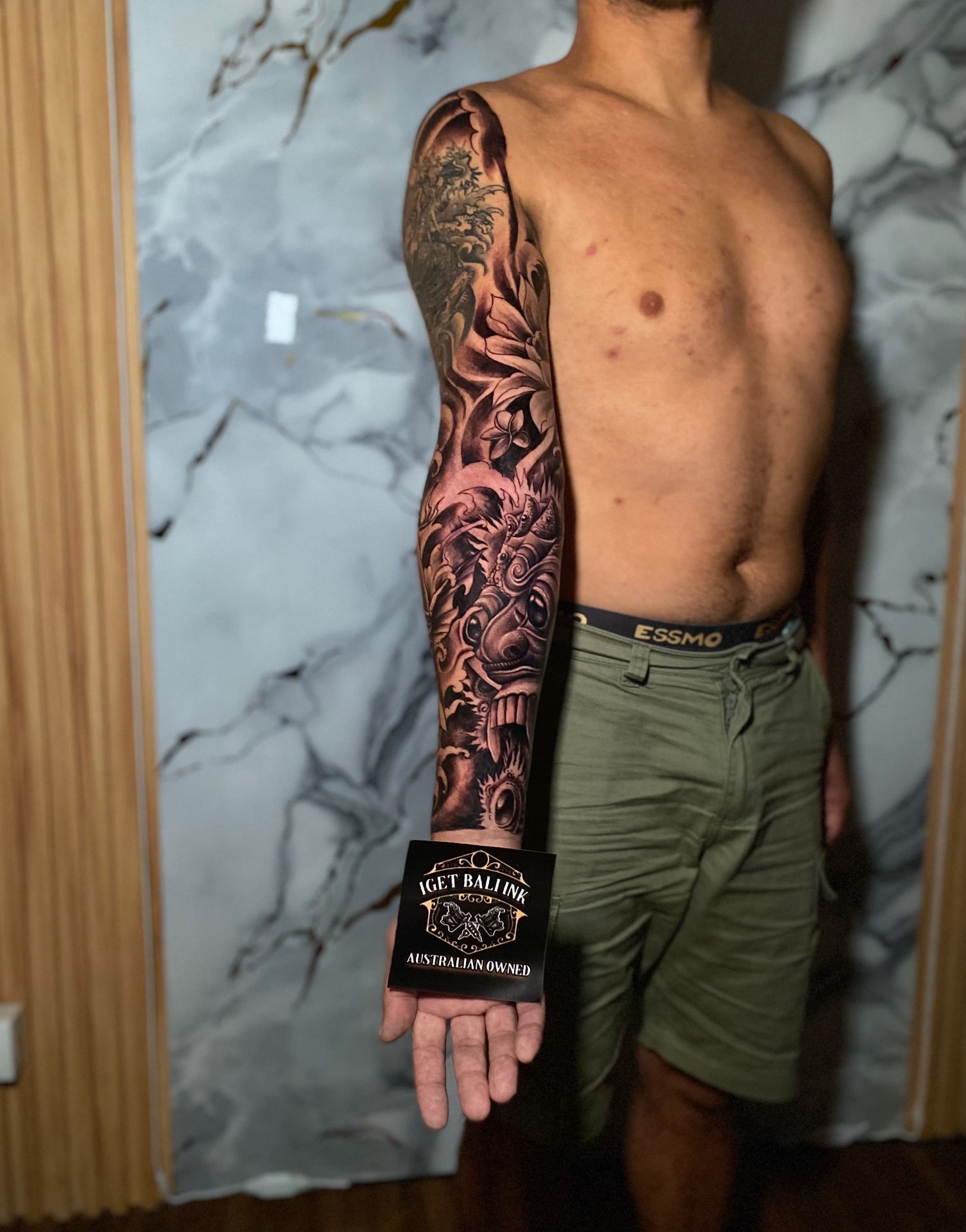 Balinese Barong mask full sleeve tattoo with florals