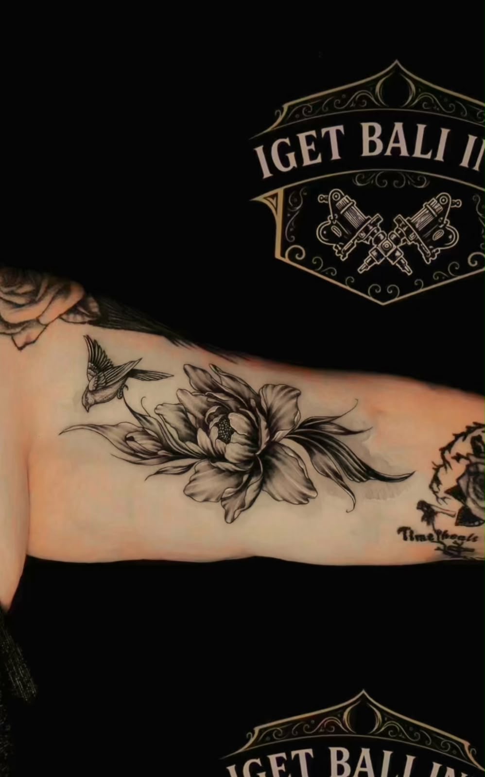 Black and grey peony and swallow inner arm tattoo