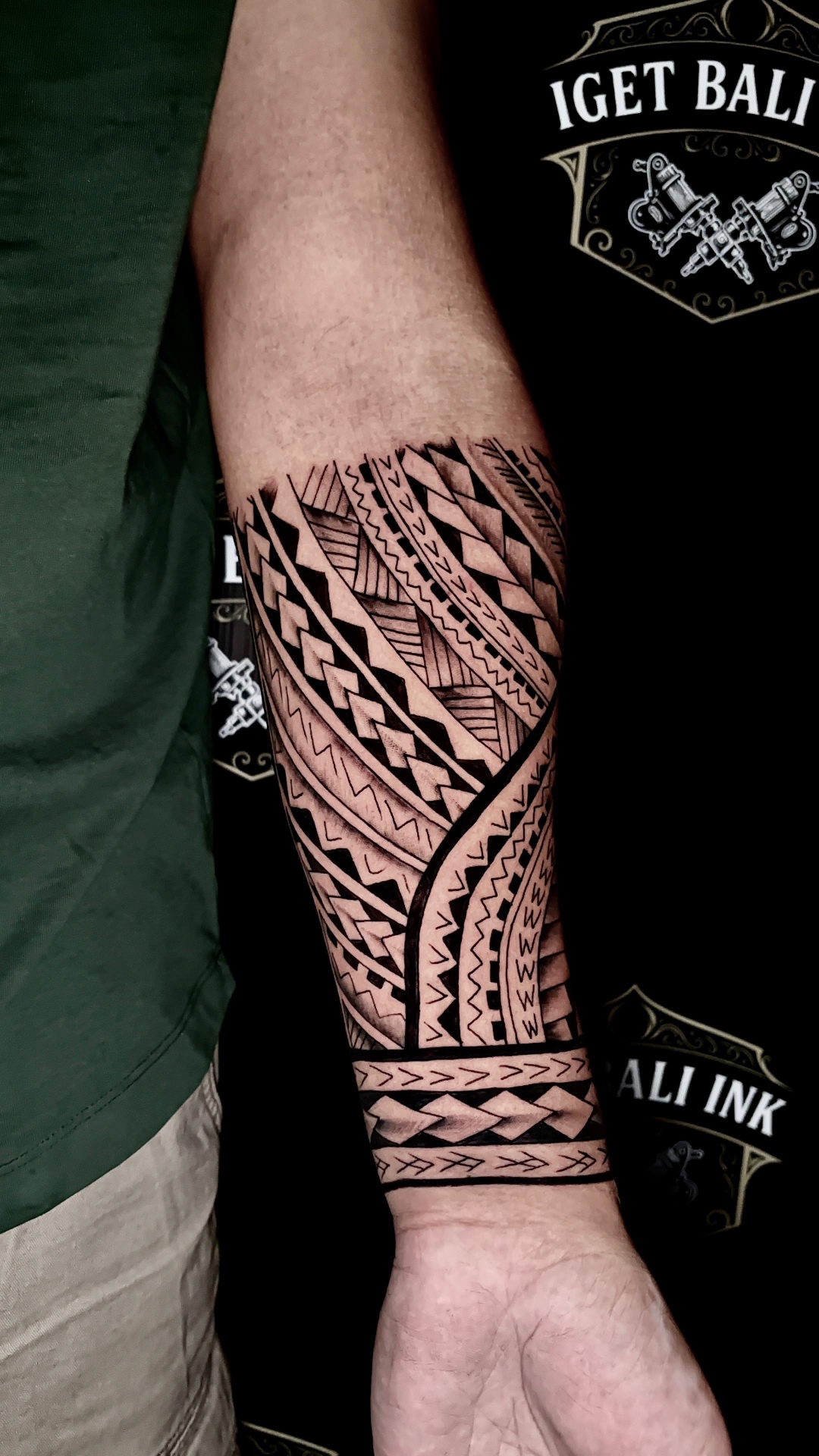 Polynesian tribal forearm band tattoo