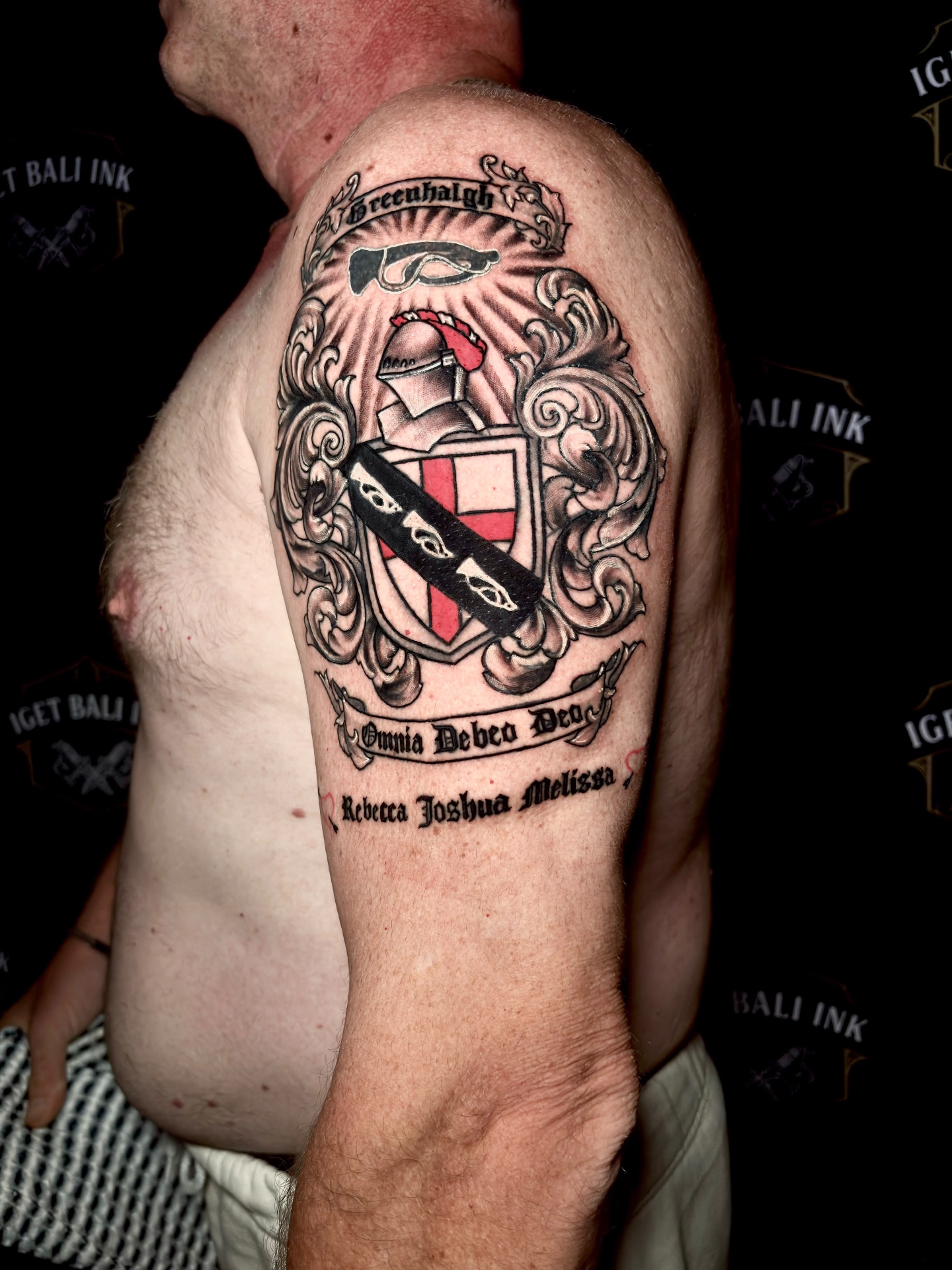Custom family crest tattoo with ornamental scrollwork