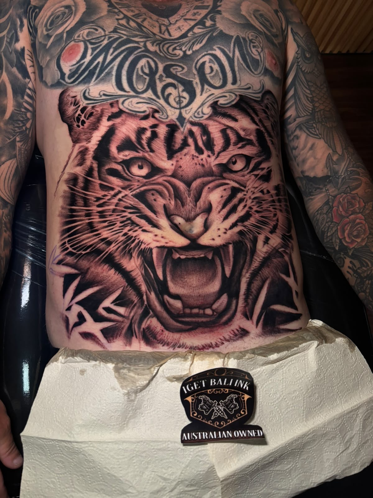 Roaring tiger stomach piece in black and grey with Mason lettering