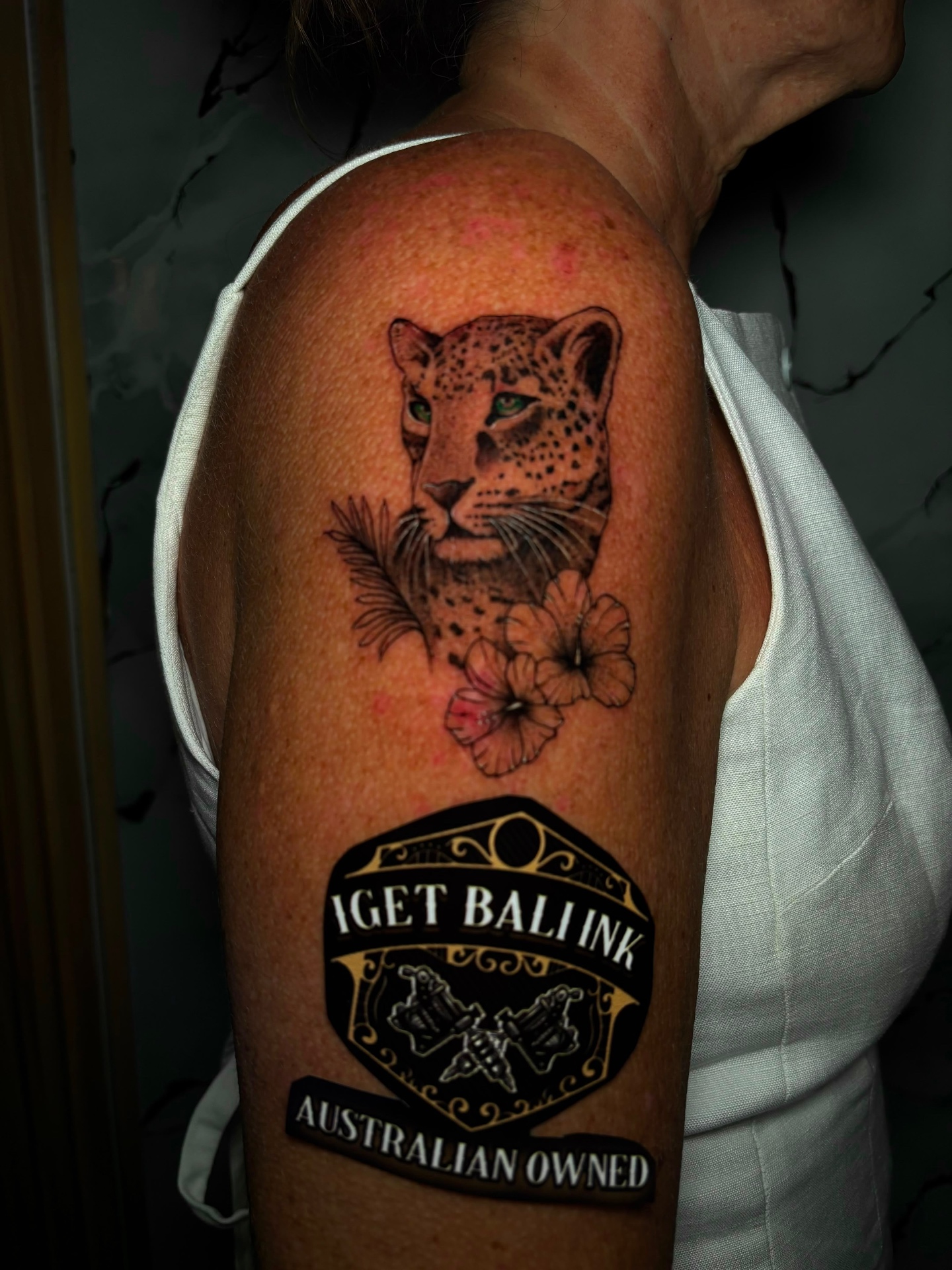 Leopard with hibiscus and palm shoulder tattoo