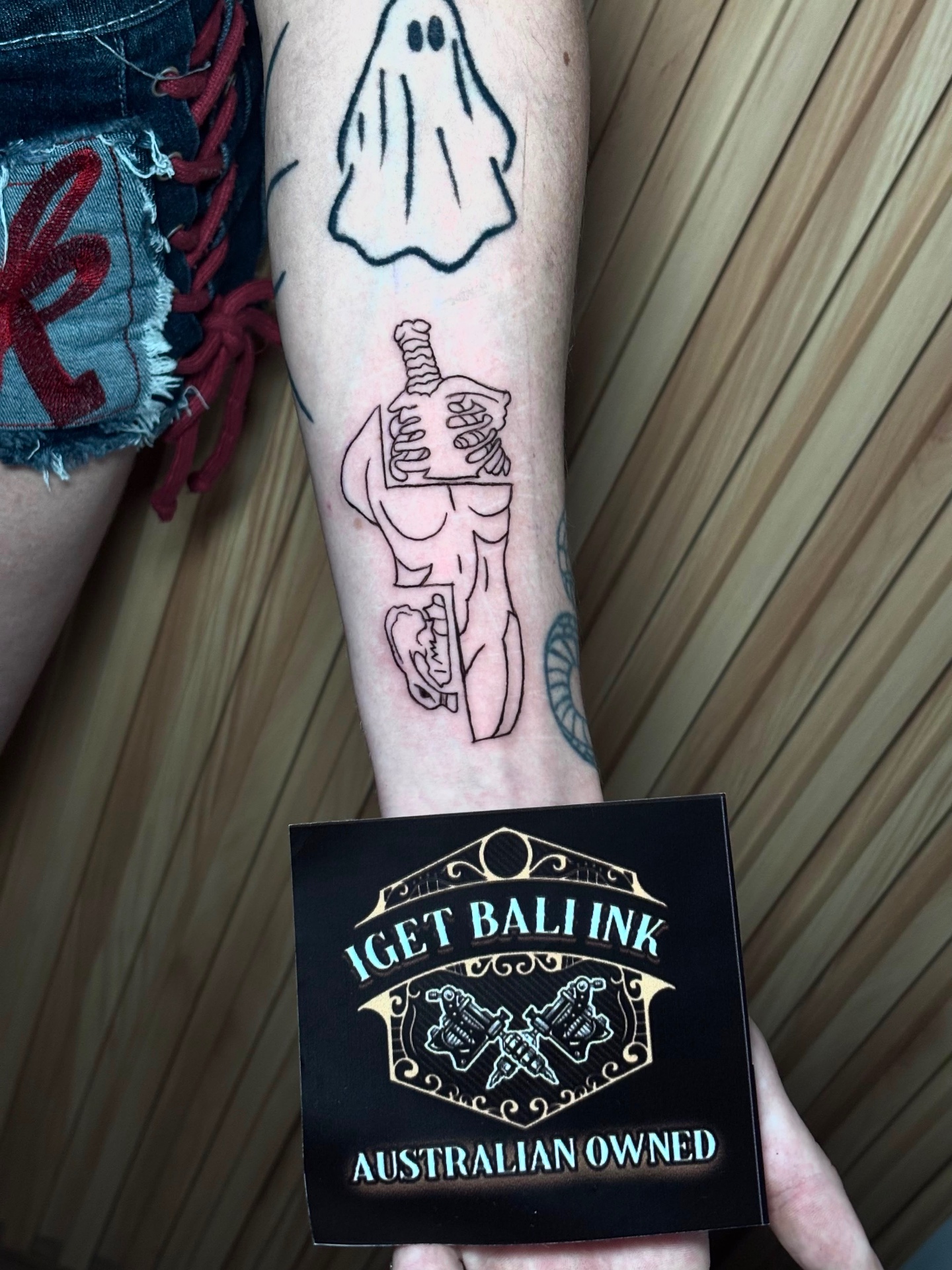 Fine line skeleton with sword forearm tattoo