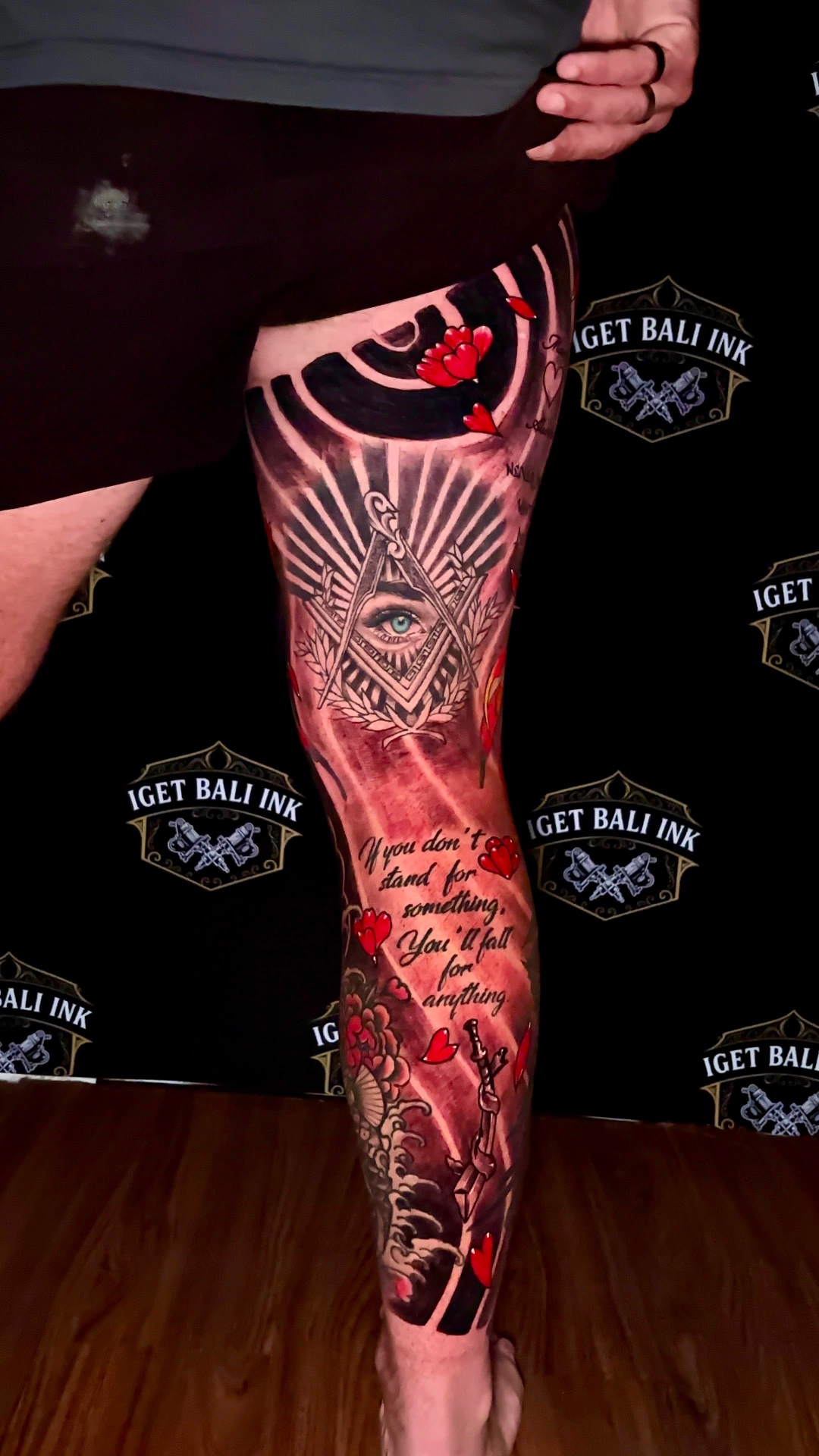 Colour full leg sleeve with all-seeing eye, script and red florals