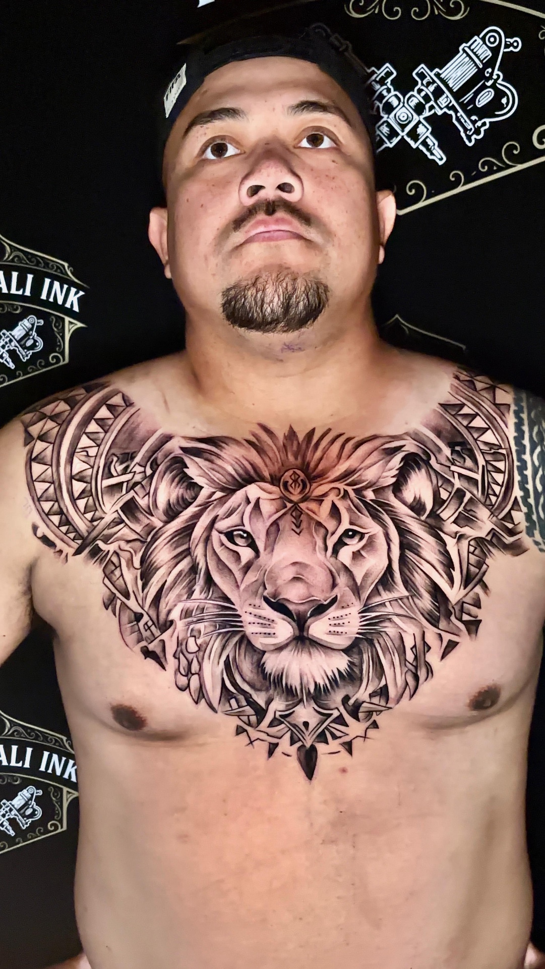 Lion chest piece with Polynesian patterning in black and grey