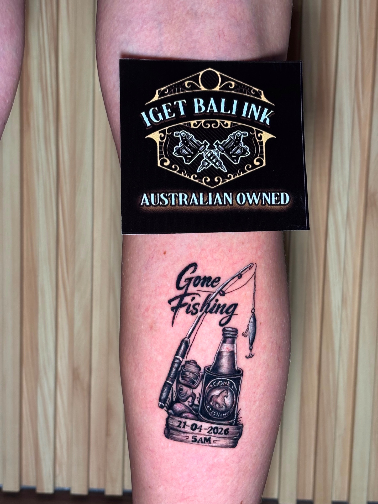 Gone Fishing memorial tattoo with rod and bottle