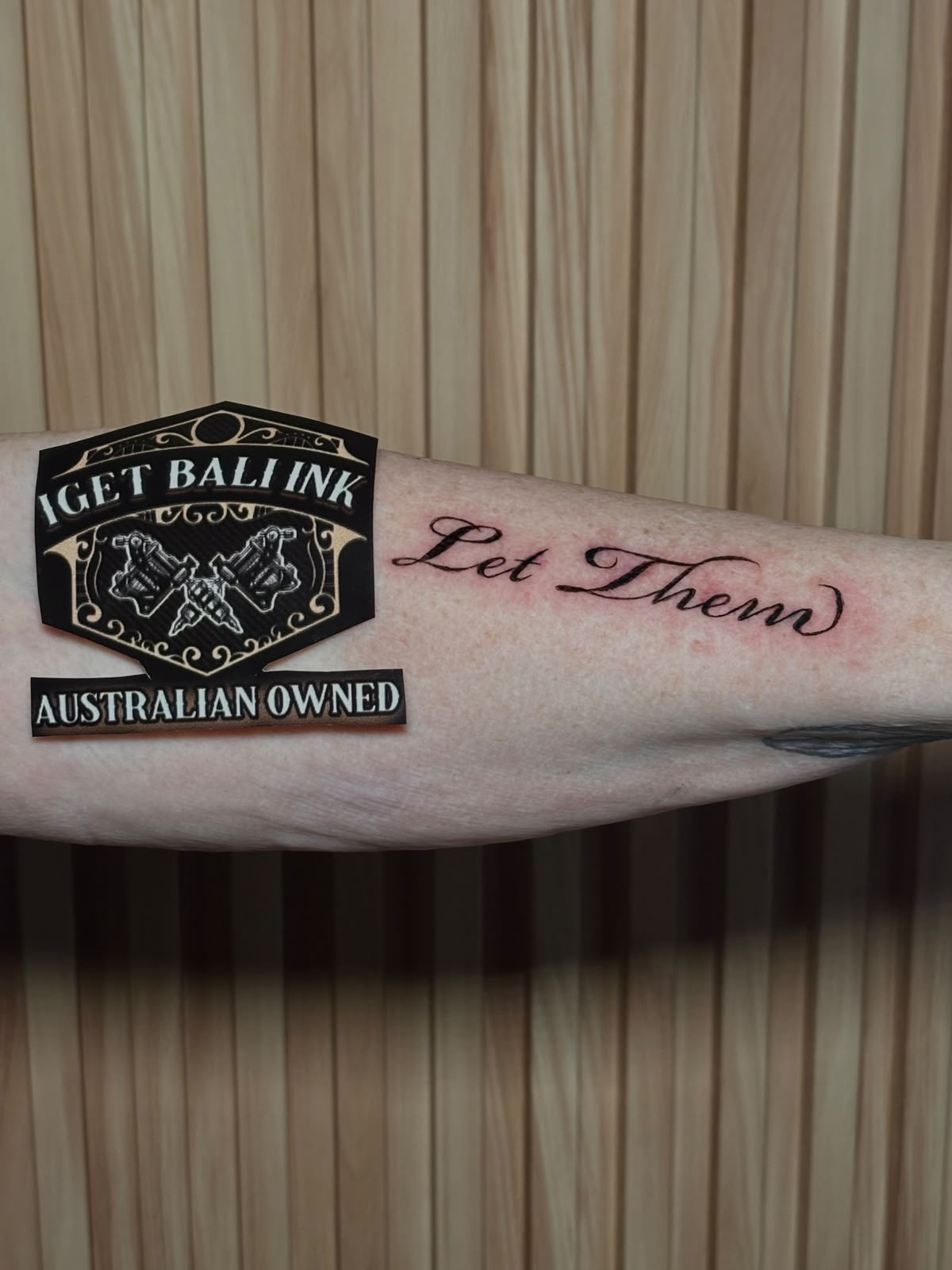 Let Them fine line script on the inner forearm