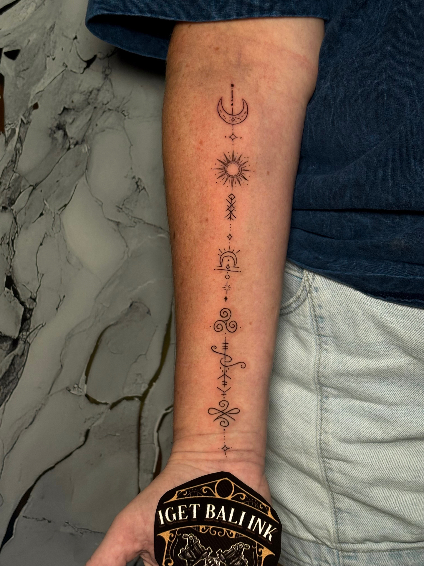 Fine line celestial sun, moon and symbols forearm strip